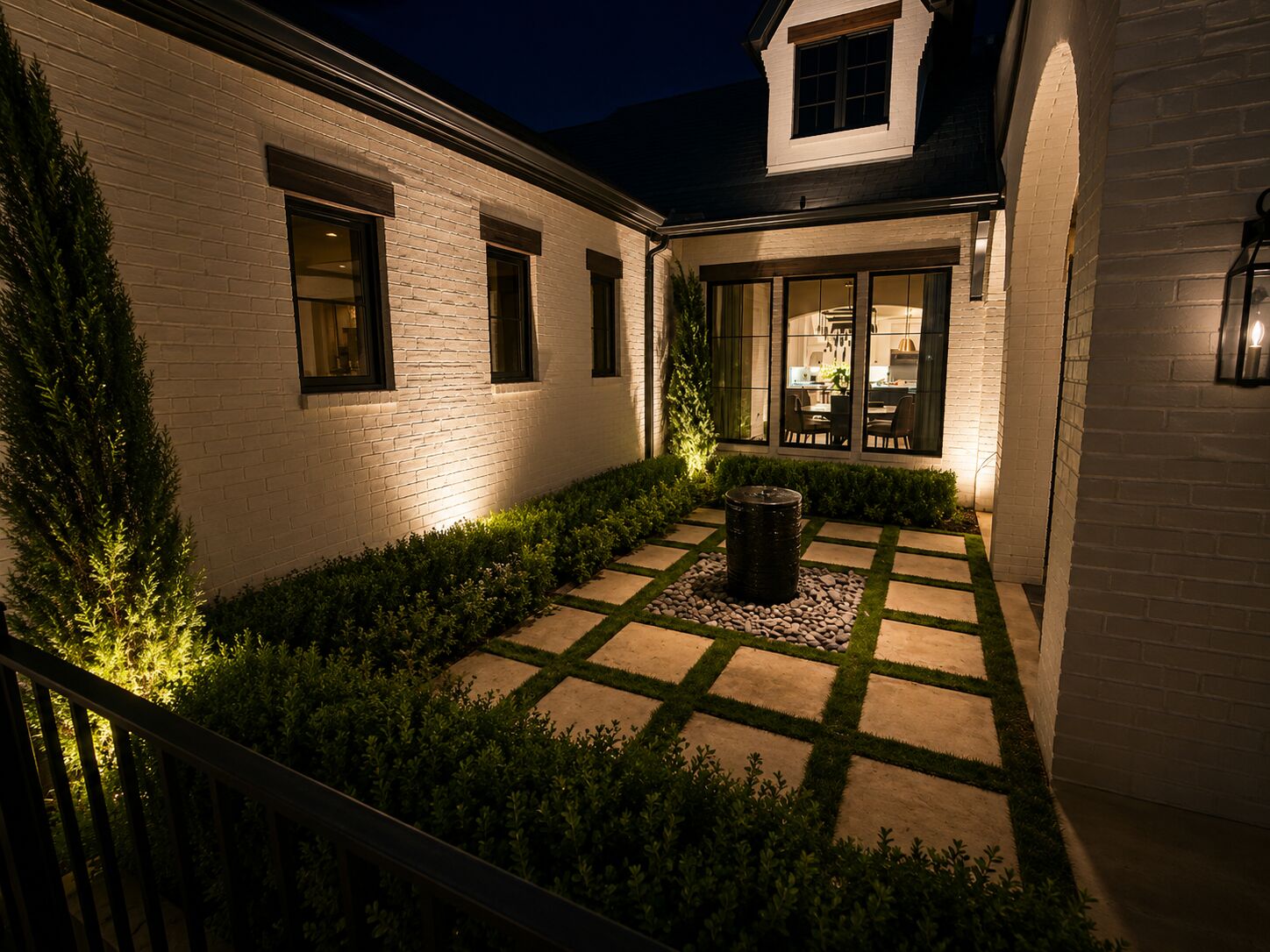 Architectural uplighting on exterior columns of a high-end North Texas home