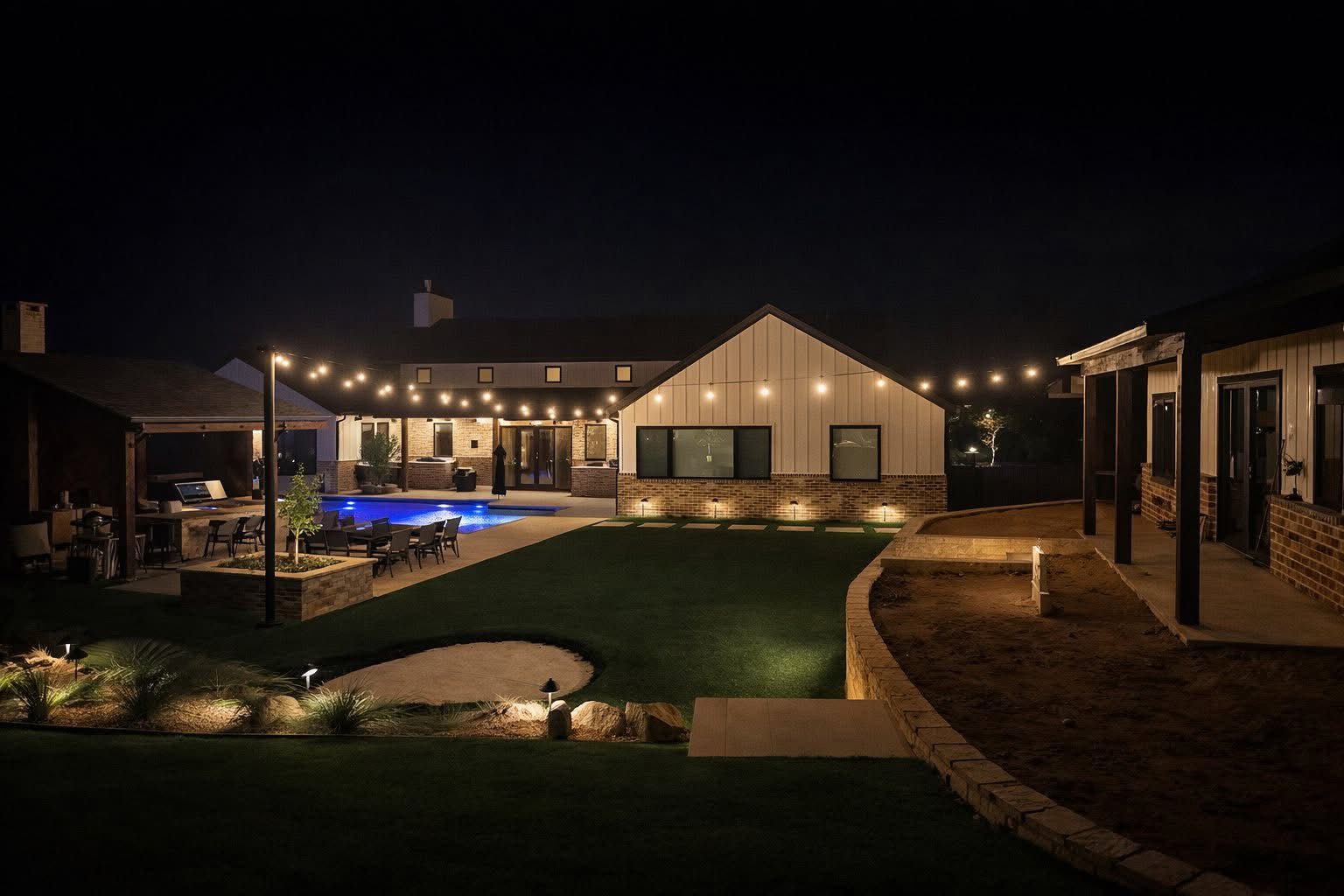 Bistro lighting with string lights over a pool and a grill