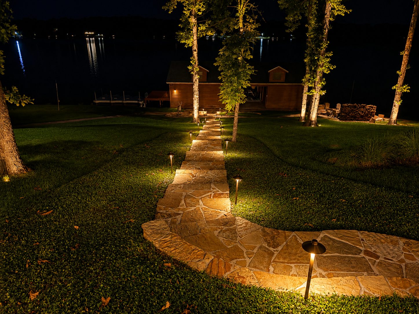 Flagstone path lights leading to a cabin and dock on a lake
