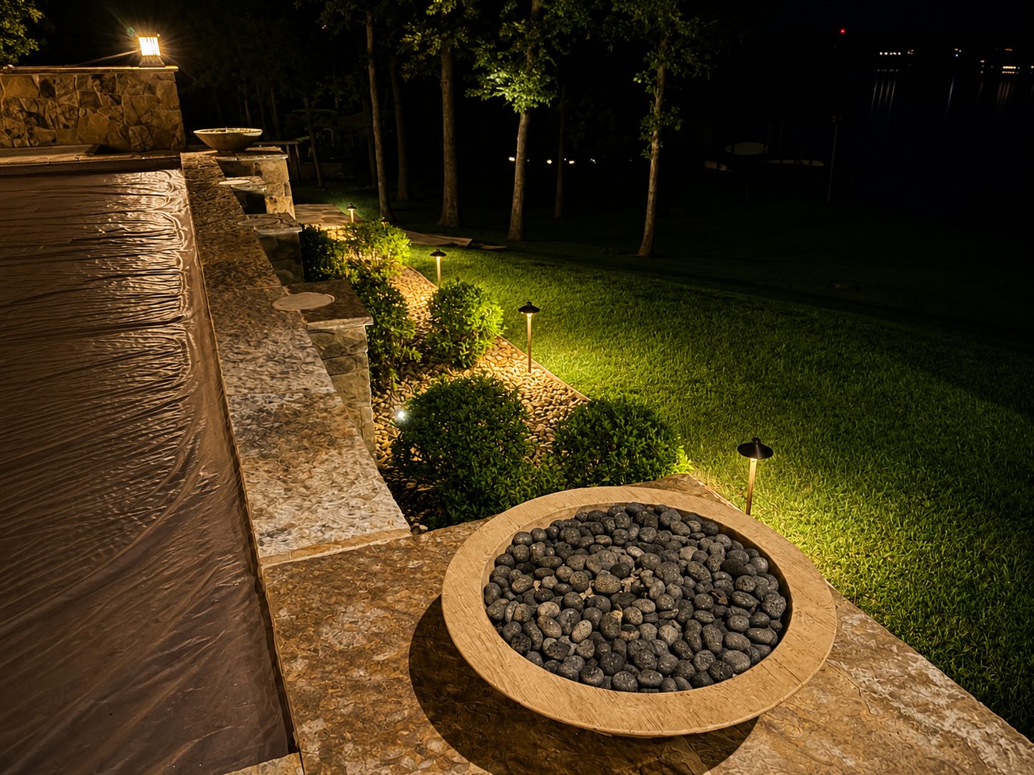 Deck with a round fire bowl and path lights along wood steps