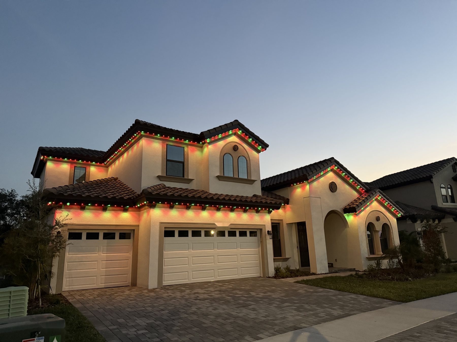 Permanent lighting on a two-story home at dusk