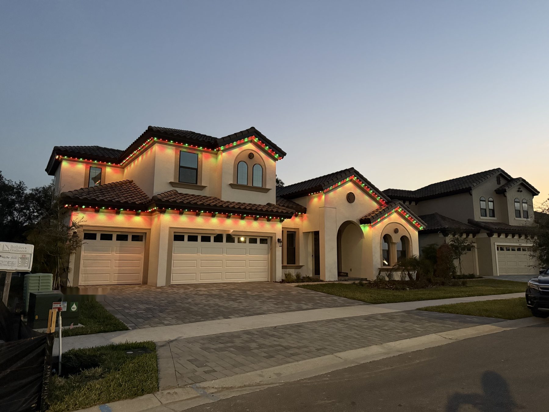 Permanent lighting along the roofline of a two-story home