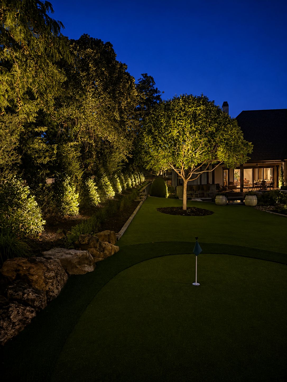 Dusk view of a path with tree uplighting